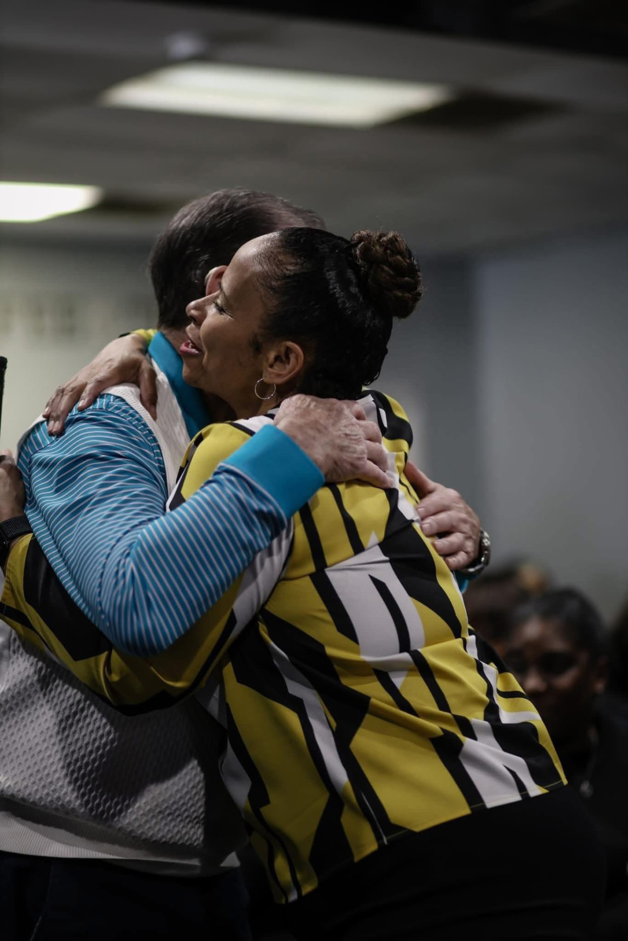 Members embracing after service